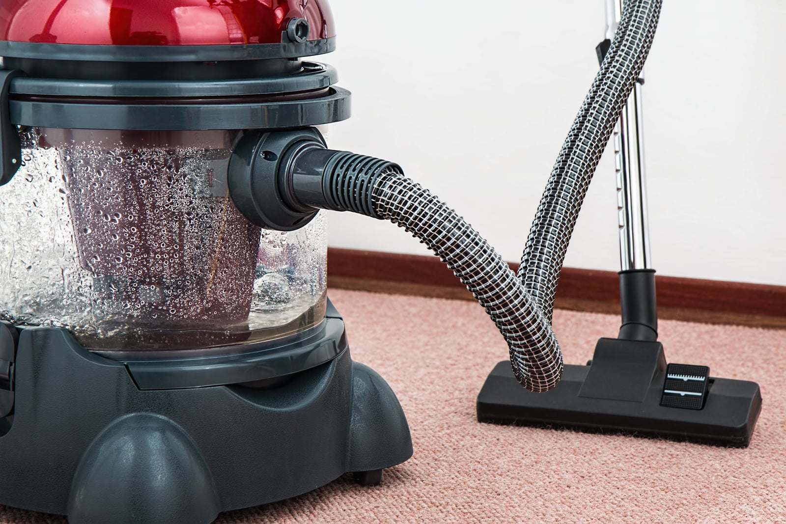A wet-and-dry canister vacuum with a hose and floor nozzle